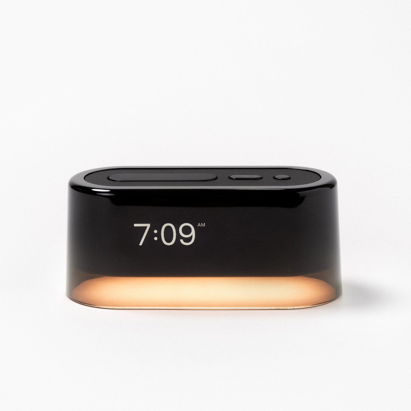 The Tuft and Needle Loftie Smart Alarm Clock with the night light on
