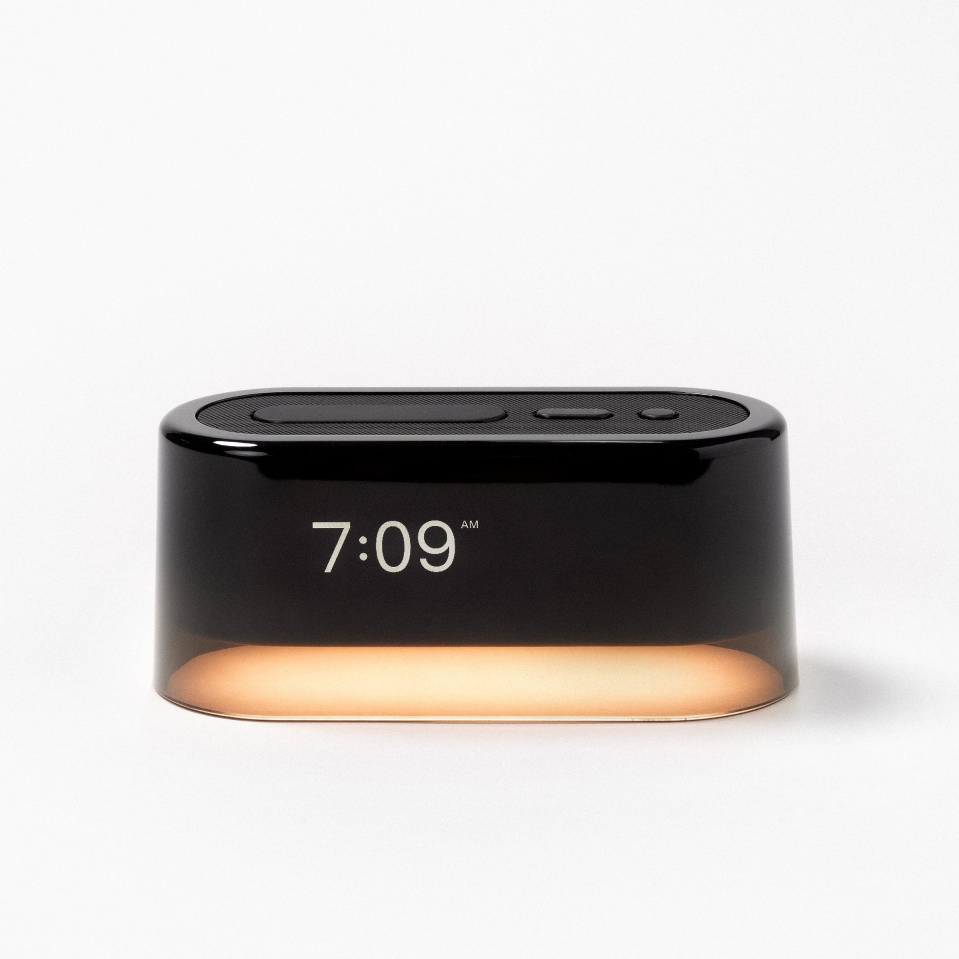 The Tuft and Needle Loftie Smart Alarm Clock with the night light on