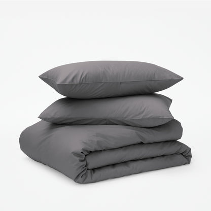 The Tuft and Needle Classic Percale Duvet Set, two pillows stacked on top of a sheet set || color: Gray Quill