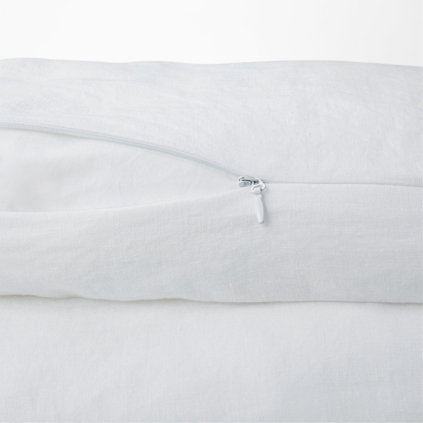 Close-up view of the zipper on the Tuft and Needle Hemp Duvet Cover ||color:honeycomb